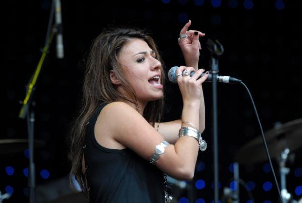 Gabriella Cilmi singing into a microphone onstage in 2009